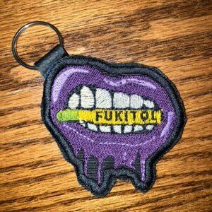Dripping wet purple lips teeth clenching bullet embroidered key chain on leather